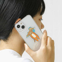 Person holding a phone with a cartoon character case against a white background